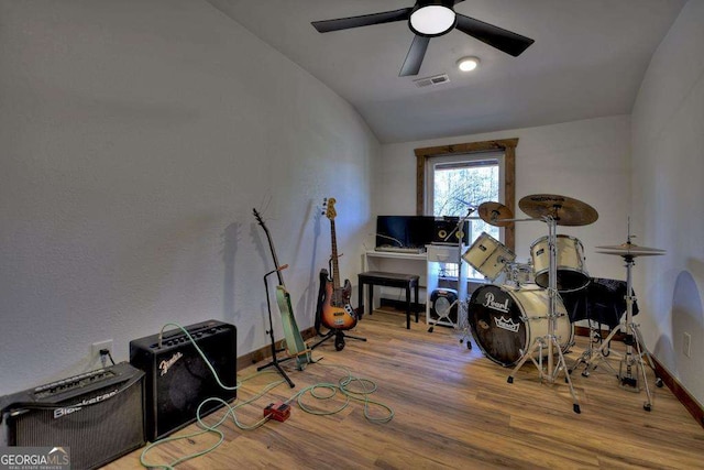 misc room with lofted ceiling, hardwood / wood-style flooring, and ceiling fan