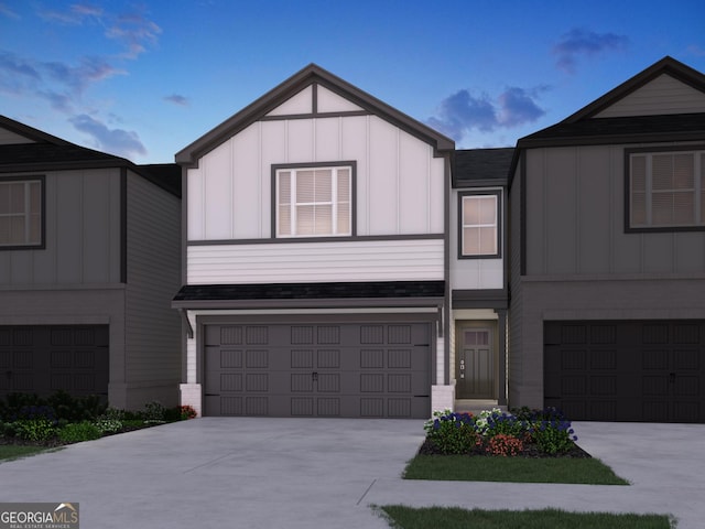 view of front of home with a garage, concrete driveway, and board and batten siding