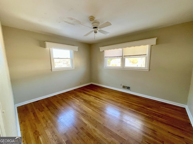 empty room featuring hardwood / wood-style flooring and ceiling fan