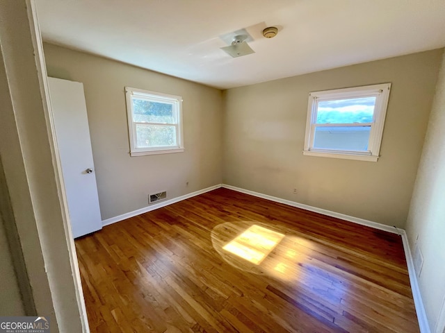 spare room featuring hardwood / wood-style floors