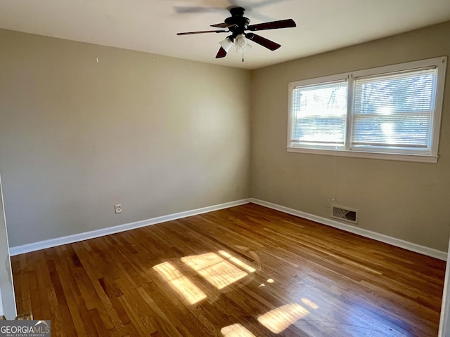 empty room featuring wood-type flooring and ceiling fan