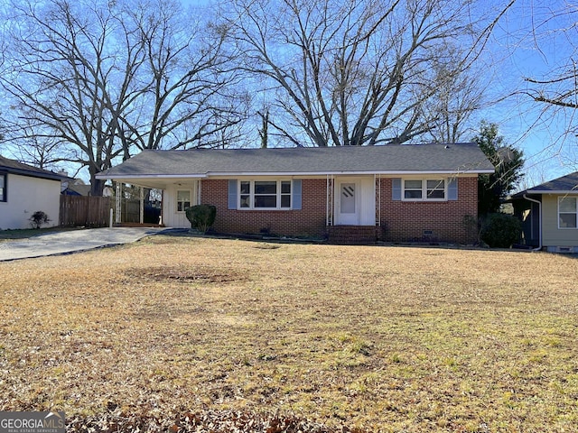 ranch-style home with a carport and a front yard