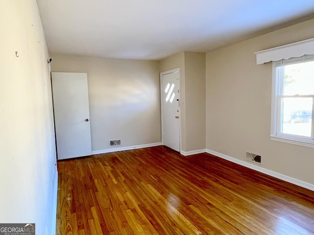 unfurnished room featuring wood-type flooring