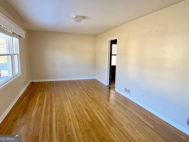 spare room with light hardwood / wood-style floors