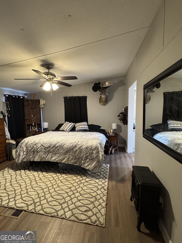 bathroom with vanity, hardwood / wood-style flooring, a textured ceiling, and toilet