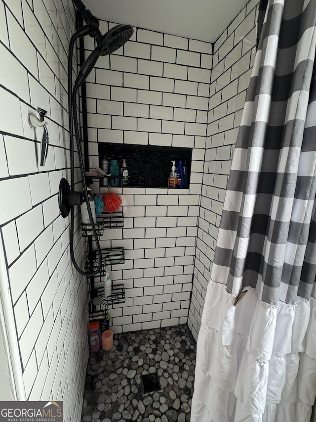 bathroom with a shower with curtain