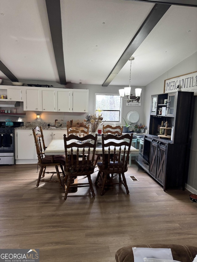 dining area with hardwood / wood-style flooring, beam ceiling, and a notable chandelier