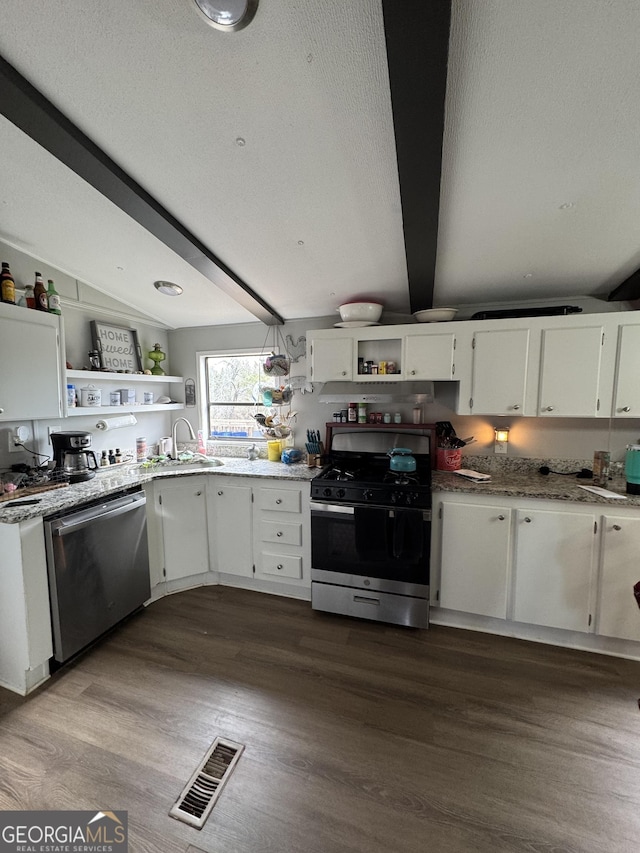 kitchen featuring vaulted ceiling with beams, white cabinets, and appliances with stainless steel finishes