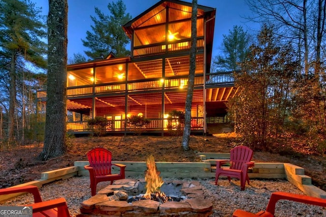 rear view of house with an outdoor fire pit