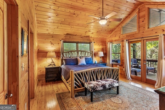 bedroom with wood walls, wood ceiling, access to outside, light wood-type flooring, and ceiling fan