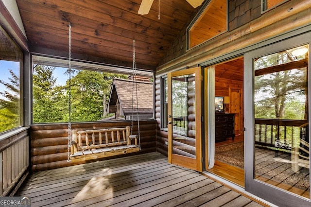 unfurnished sunroom featuring wood ceiling, lofted ceiling, and plenty of natural light