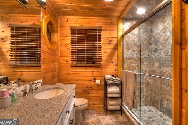 bathroom with vanity, wood ceiling, wooden walls, and a shower with door