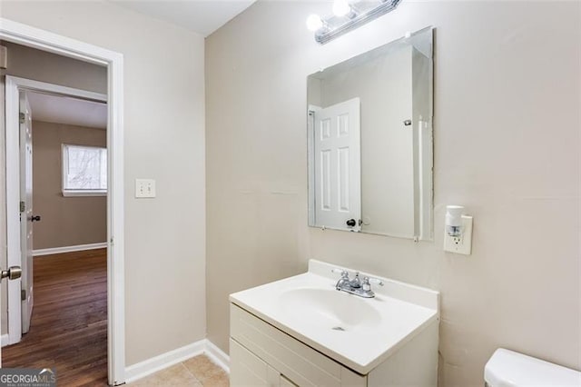 bathroom featuring vanity, tile patterned floors, and toilet