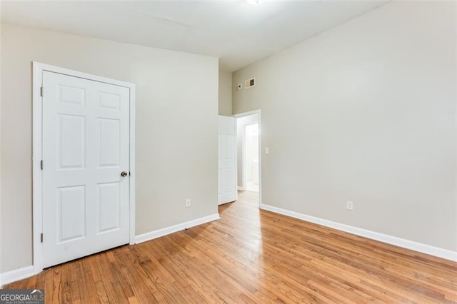 spare room with light hardwood / wood-style floors