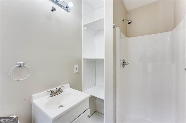 bathroom with walk in shower and vanity