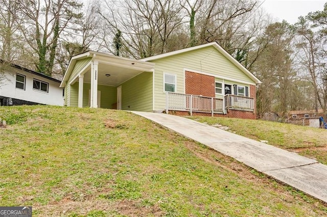 ranch-style home featuring a carport and a front yard