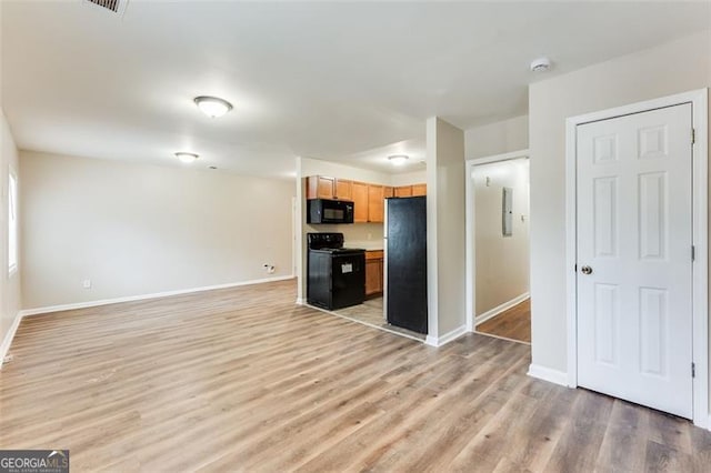 unfurnished living room featuring light hardwood / wood-style floors