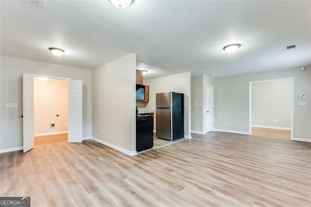 unfurnished living room with light hardwood / wood-style flooring