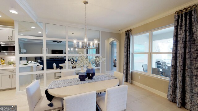 dining space featuring ornamental molding, a tray ceiling, and a notable chandelier