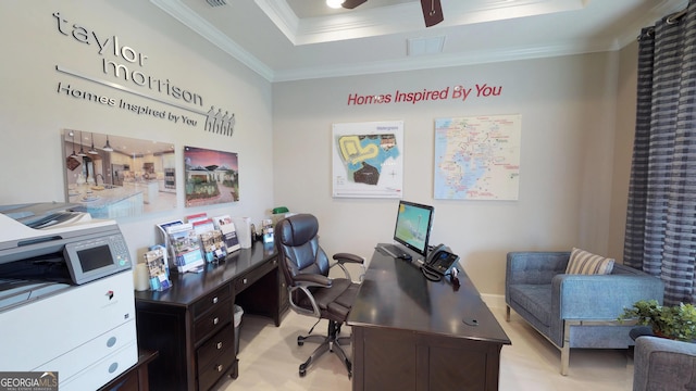 office space with ornamental molding, a raised ceiling, visible vents, and a ceiling fan