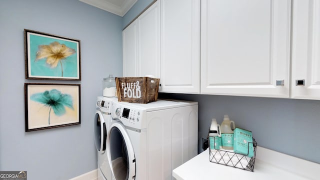 laundry room with cabinet space, ornamental molding, and washer and clothes dryer