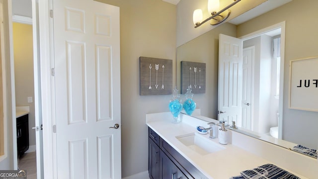 bathroom featuring toilet and vanity