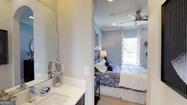 bedroom with ceiling fan, arched walkways, a sink, and recessed lighting