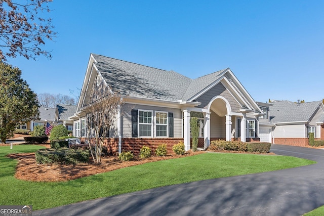 view of front of property featuring a garage and a front lawn