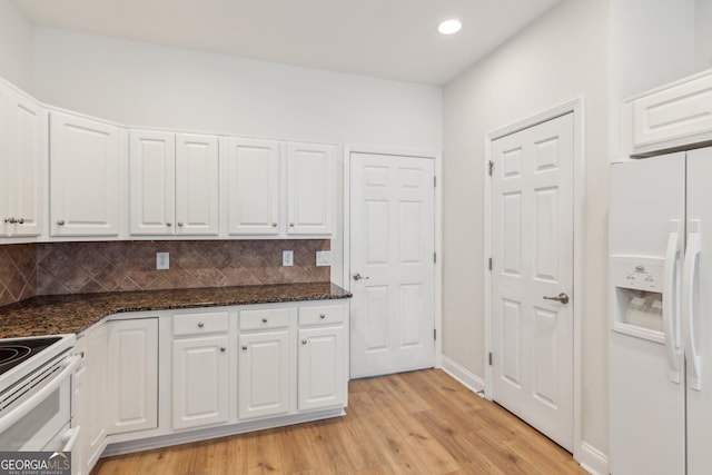 kitchen with white cabinetry, white appliances, light hardwood / wood-style floors, and backsplash