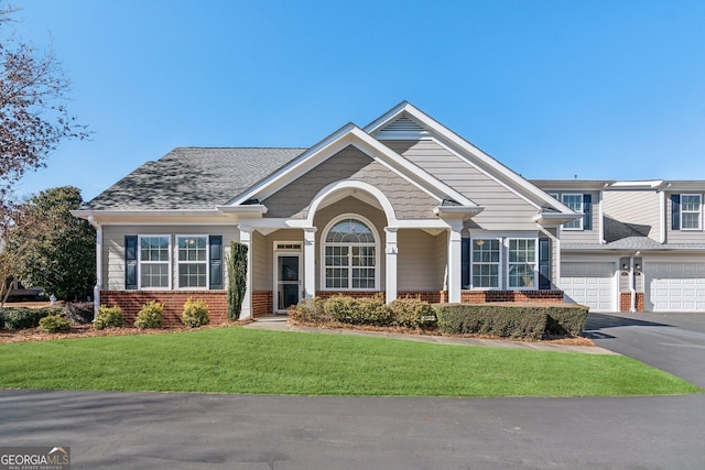 view of front of home featuring a garage and a front lawn