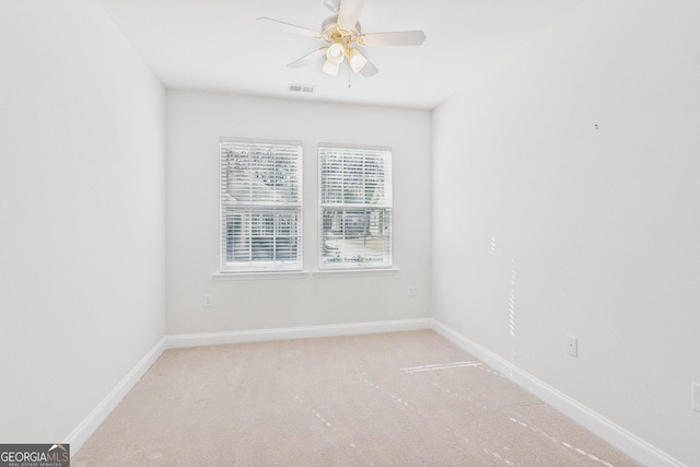 spare room with ceiling fan and carpet floors