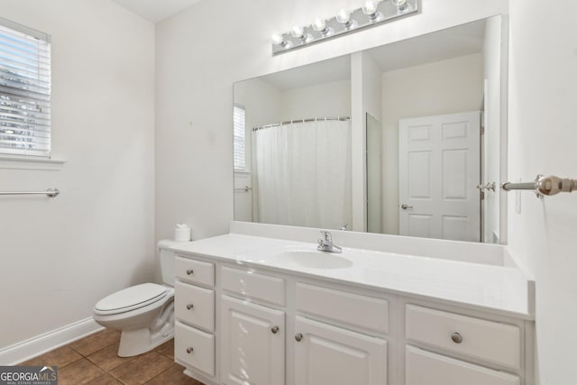 bathroom featuring tile patterned flooring, vanity, a shower with curtain, and toilet