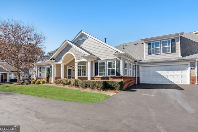 view of front of home featuring a garage and a front lawn