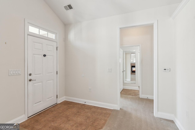 entryway with light colored carpet and lofted ceiling