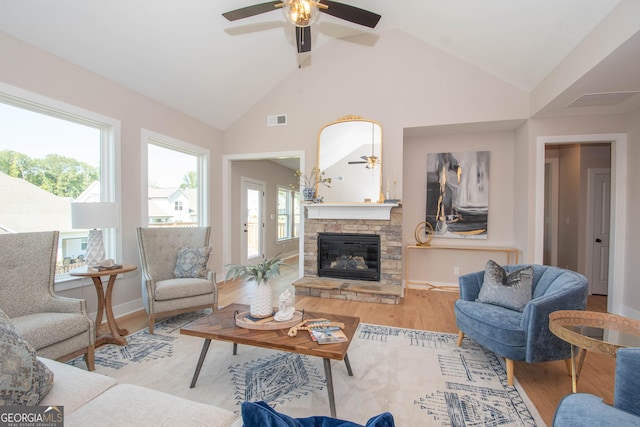 69 Oakhurst Trl, Sharpsburg, GA 30277 - living area featuring a ceiling fan, wood finished floors, vaulted ceiling, and a stone fireplace
