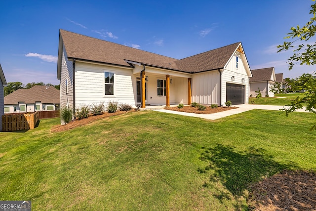 69 Oakhurst Trl, Sharpsburg, GA 30277 - view of front facade with driveway, board and batten siding, roof with shingles, a garage, and a porch