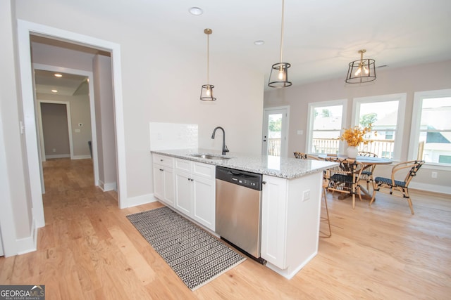 69 Oakhurst Trl, Sharpsburg, GA 30277 - kitchen featuring stainless steel dishwasher, white cabinetry, light wood finished floors, light stone countertops, and pendant lighting