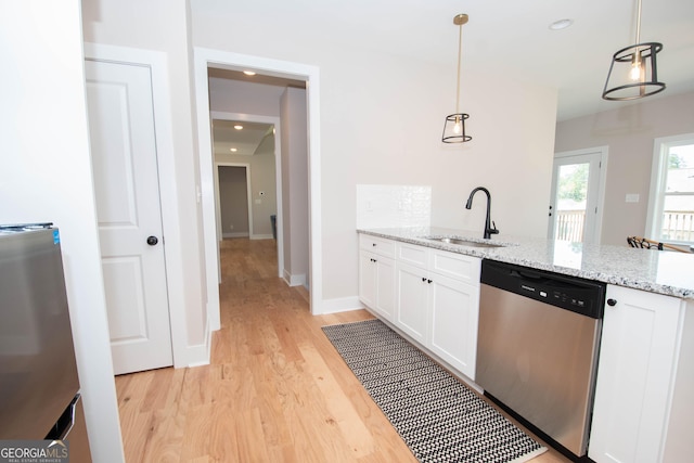 69 Oakhurst Trl, Sharpsburg, GA 30277 - kitchen with dishwasher, light wood finished floors, white cabinets, a peninsula, and light stone countertops