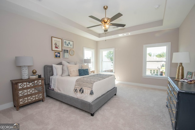 69 Oakhurst Trl, Sharpsburg, GA 30277 - bedroom with a raised ceiling, light carpet, and a ceiling fan