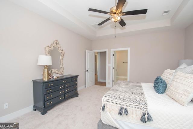 69 Oakhurst Trl, Sharpsburg, GA 30277 - bedroom featuring a tray ceiling, light colored carpet, and ceiling fan