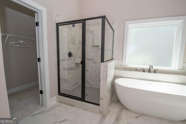 69 Oakhurst Trl, Sharpsburg, GA 30277 - full bath with a freestanding bath, a spacious closet, a stall shower, and marble finish flooring