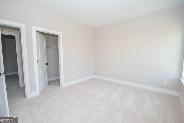 69 Oakhurst Trl, Sharpsburg, GA 30277 - unfurnished bedroom with light carpet, a spacious closet, and a closet