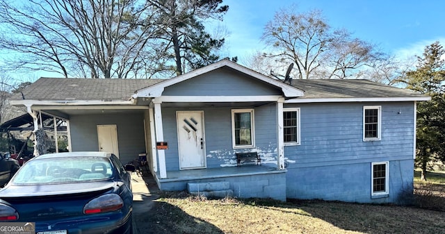 view of front of home with a porch and a carport