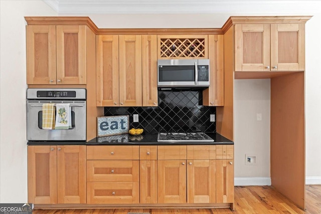 kitchen with tasteful backsplash, crown molding, light hardwood / wood-style floors, and appliances with stainless steel finishes