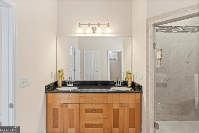 bathroom with walk in shower and vanity