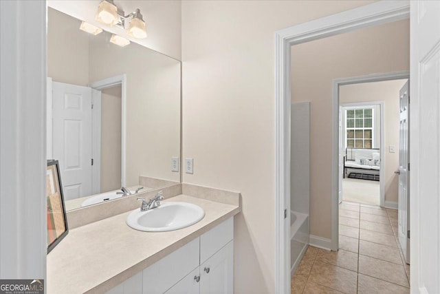 bathroom with vanity, a bathing tub, and tile patterned floors