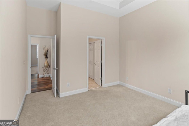 unfurnished bedroom with light colored carpet