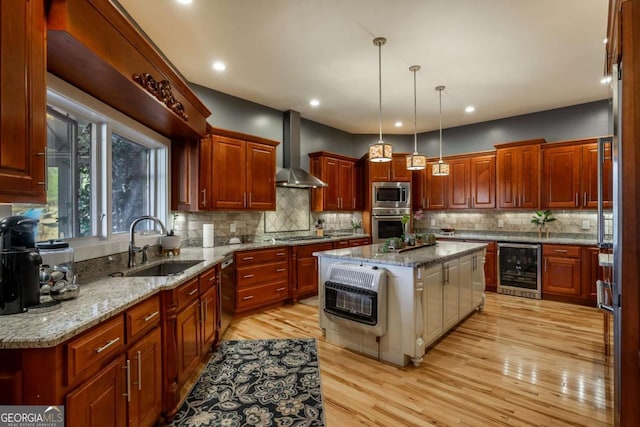 kitchen featuring wall chimney range hood, stainless steel appliances, a center island, decorative light fixtures, and beverage cooler