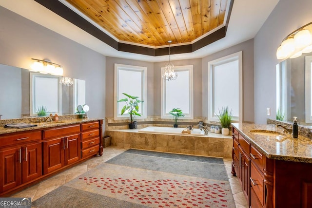 bathroom with a notable chandelier, wooden ceiling, a raised ceiling, and a healthy amount of sunlight