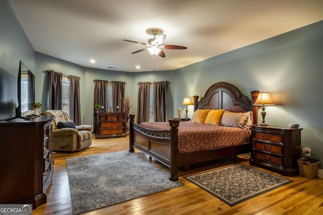 bedroom with hardwood / wood-style flooring and ceiling fan